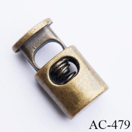 Stop cordon jusqu'au 5 mm couleur laiton hauteur 21 mm largeur 11.5 mm épaisseur 7.5 mm passage du cordon en largeur 6.5 mm