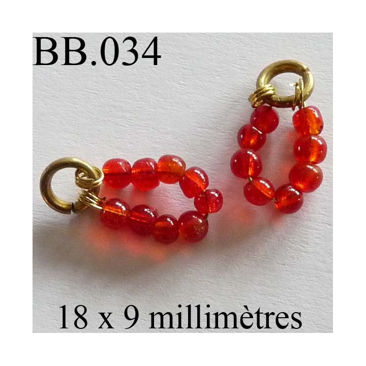 perle  biche de bere  monté  longueur 18 mm largeur 9 mm  couleur orange rouge vendu a la pièce