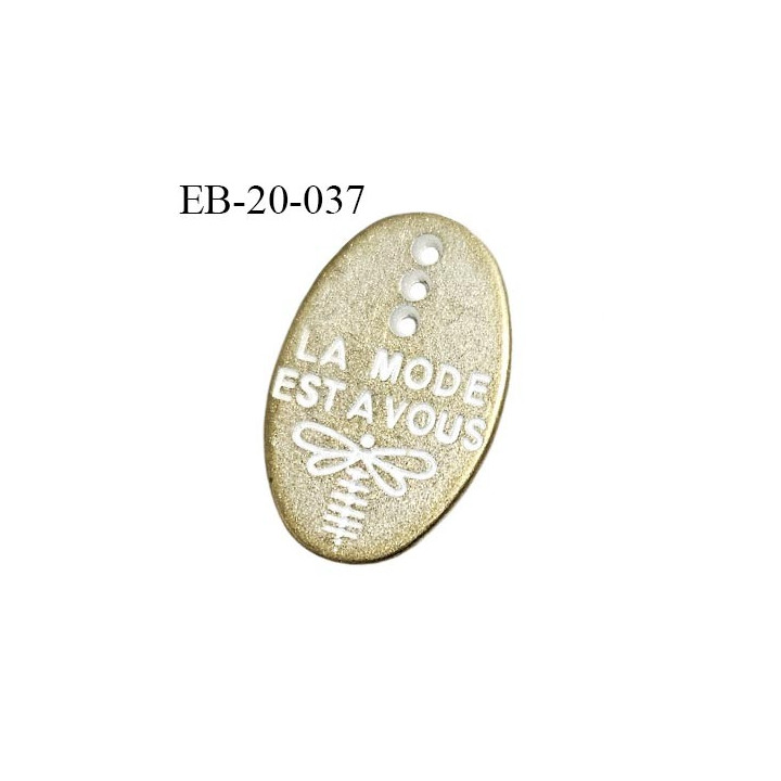 Plaque en métal couleur doré avec 3 trous inscription blanche La mode est à vous largeur 13 mm hauteur 20 mm prix à la pièce