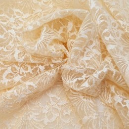 Dentelle brodé  sur tulle extensible dans la largeur  couleur pèche clair très haut de gamme largeur 140 cm